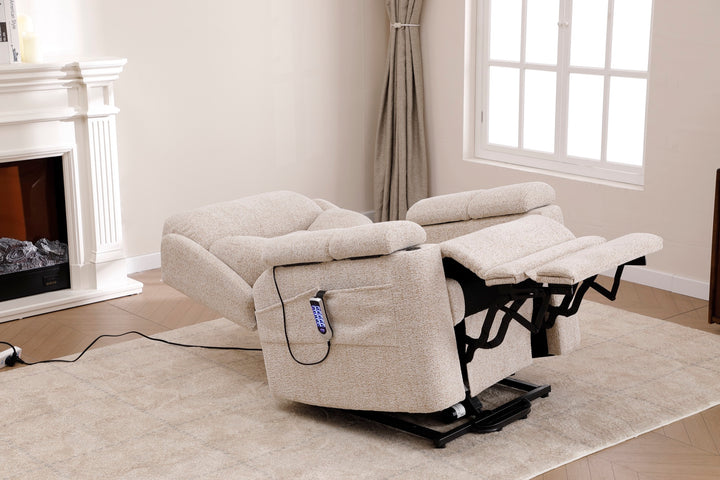 Dynox X5 power recliner in zero-gravity position with extended footrest in a modern living room · Designed in New Jersey